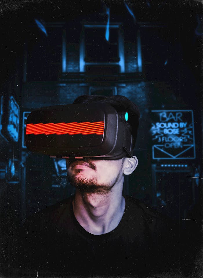 services-01 Young man immersed in a virtual reality experience using a VR headset, showcasing futuristic tech in a gaming environment.