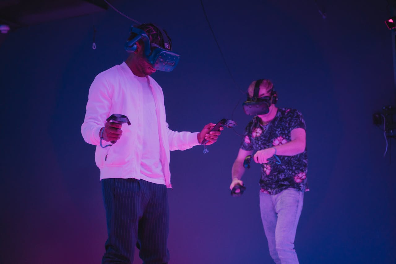 Home Two men wearing VR headsets and controllers immersed in a virtual reality gaming environment.